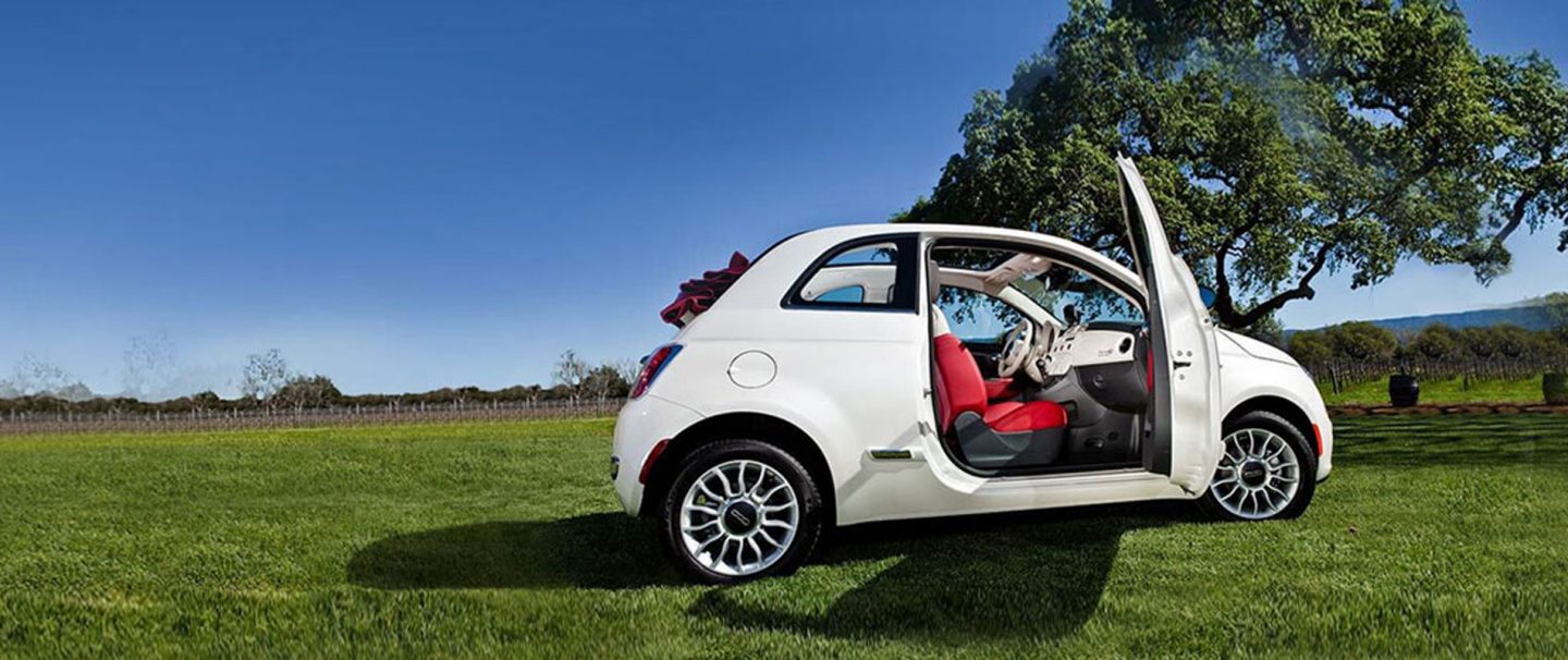 Overhead view of a 2019 Fiat 500 Pop parked on the roof of a parking structure.